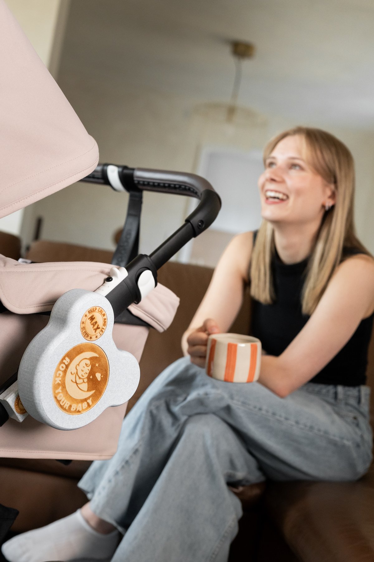Eine Mutter genießt einen ruhigen Moment, während ROCK your BABY den Schlafplatz ihres Babys sanft weiterbewegt.