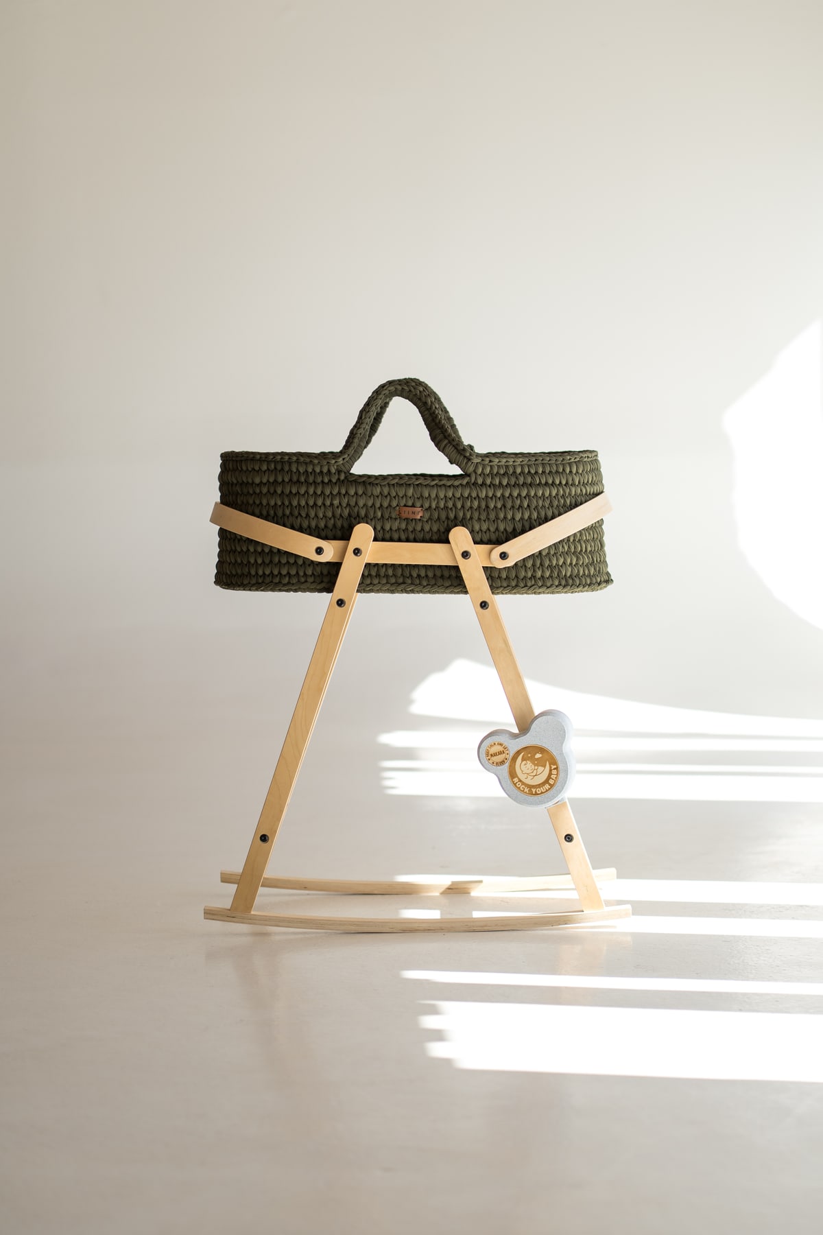 ROCK your BABY attached to a rocking cradle with a curved runner